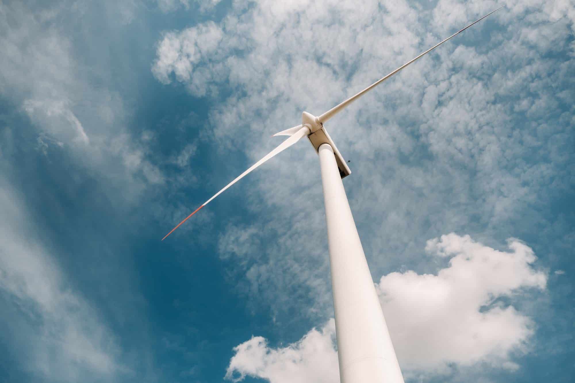 A white Windmill against a blue sky. Windmill in nature