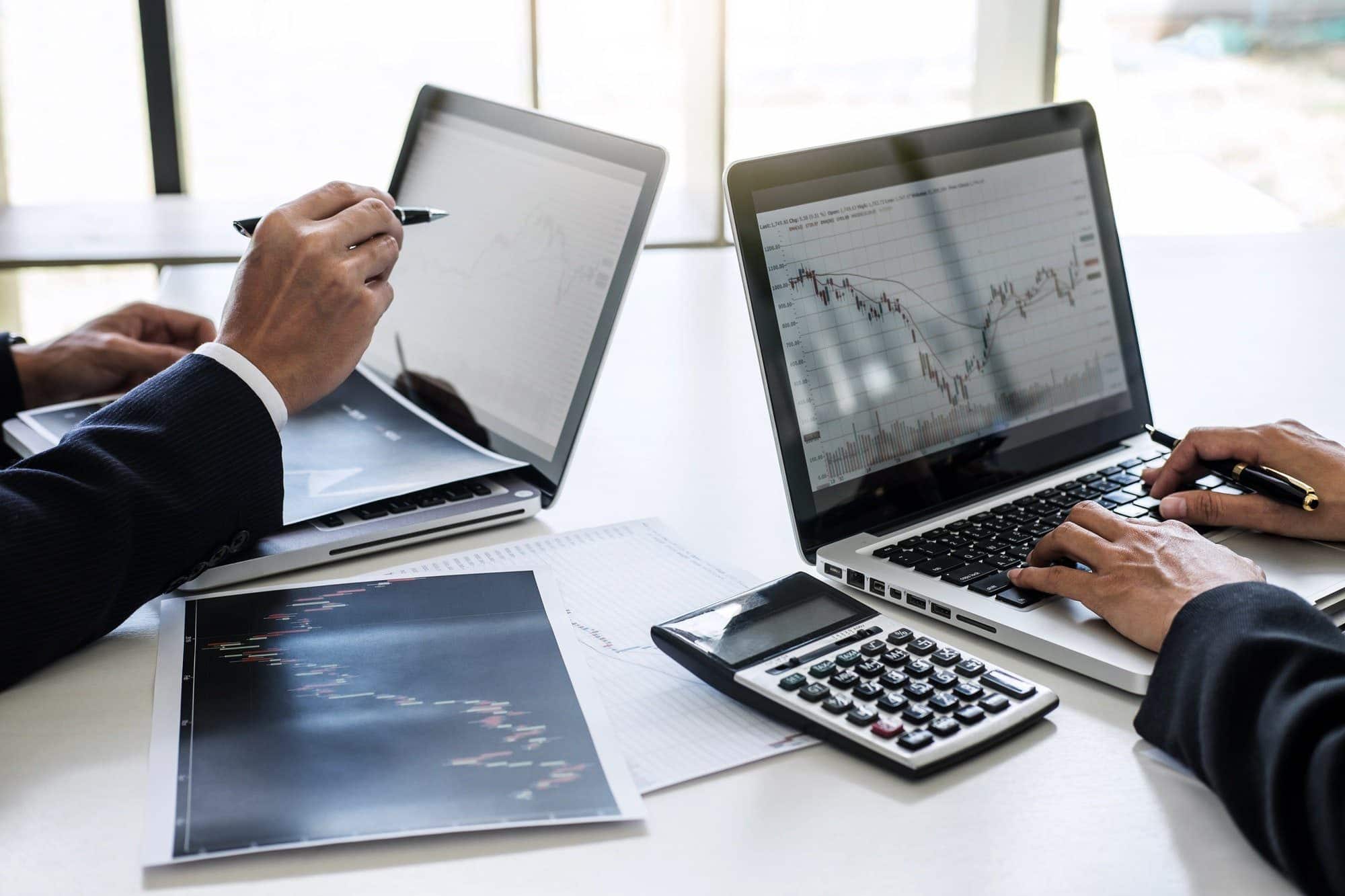 Business team investment working with computer and analysis graph stock market trading with stock