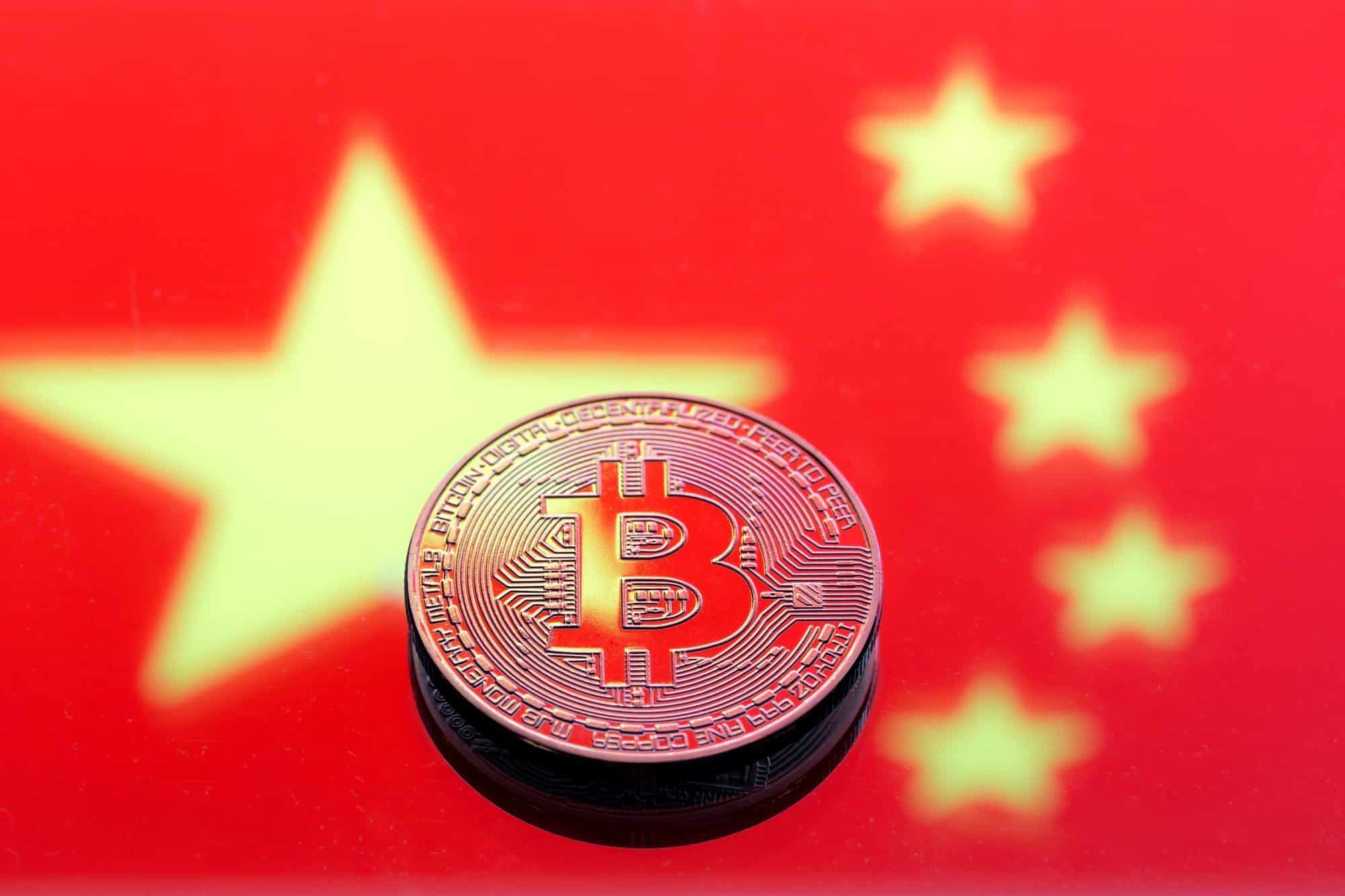 Coins Bitcoin, against the background of the Chinese flag.