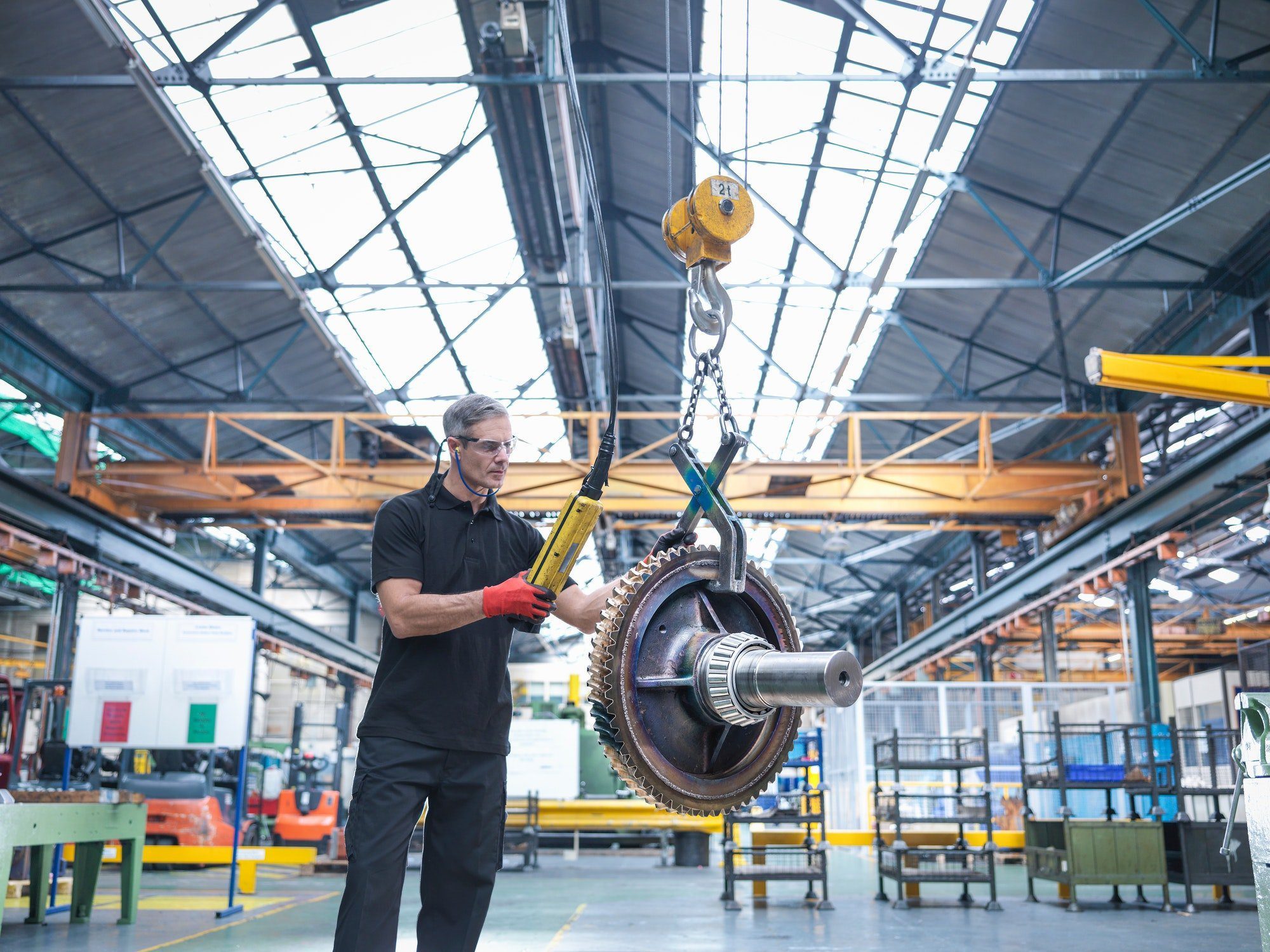 Engineer assembling industrial gearbox in engineering factory