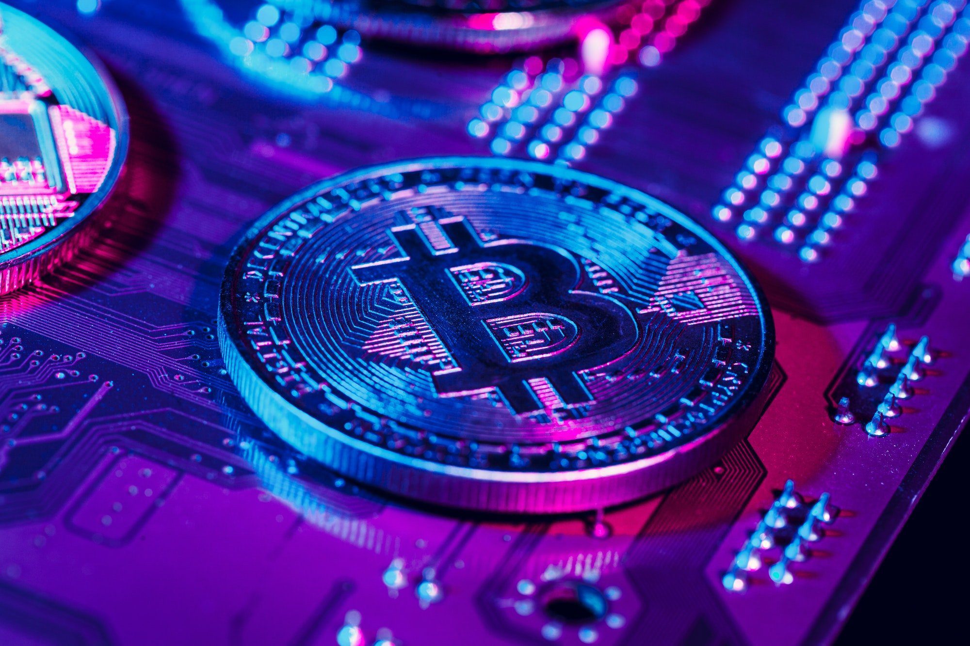 golden bitcoin and computer chip in background
