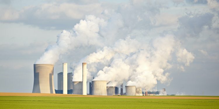Green Fields In Front Of Industry Skyline
