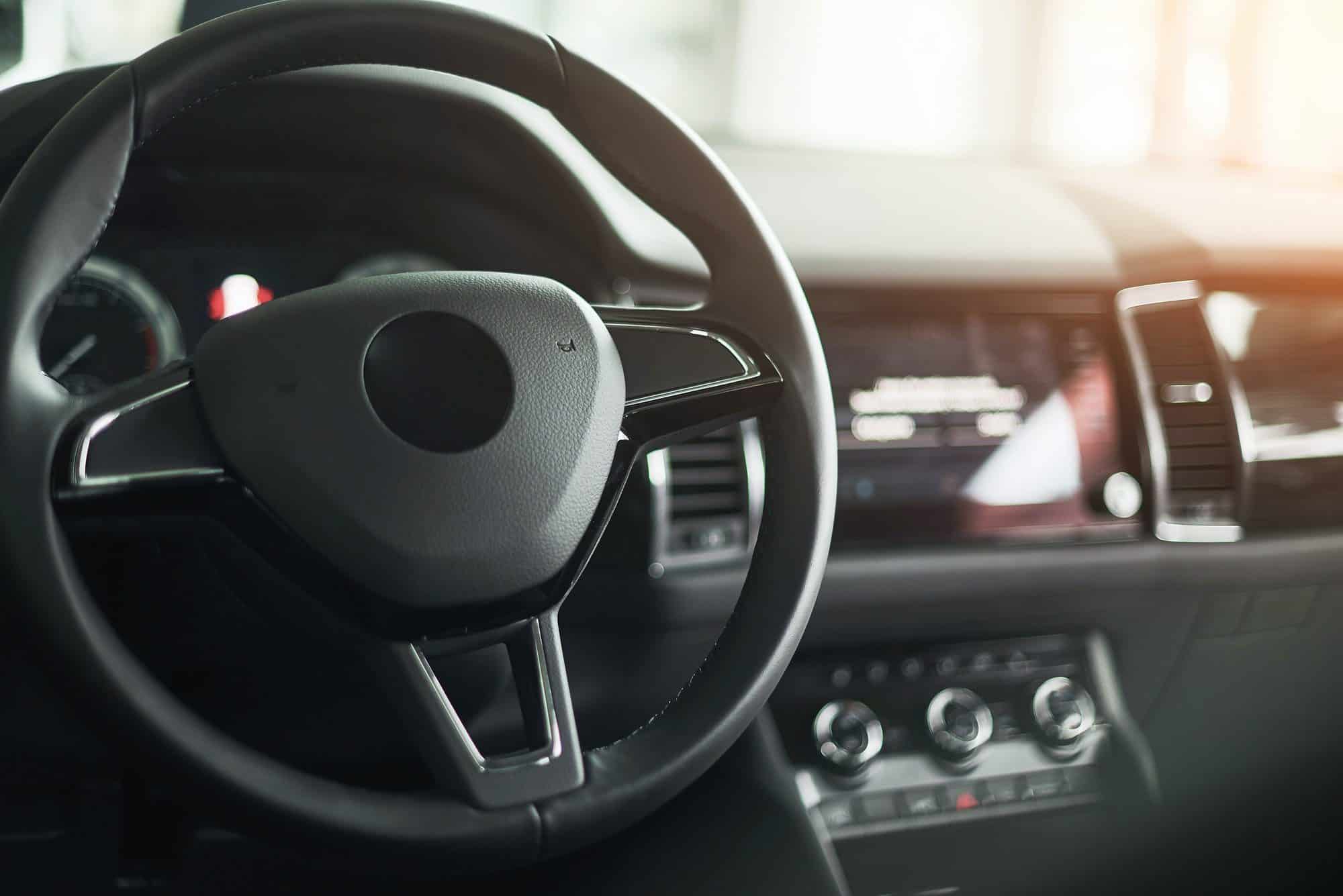 Luxury car Interior - steering wheel, shift lever and dashboard