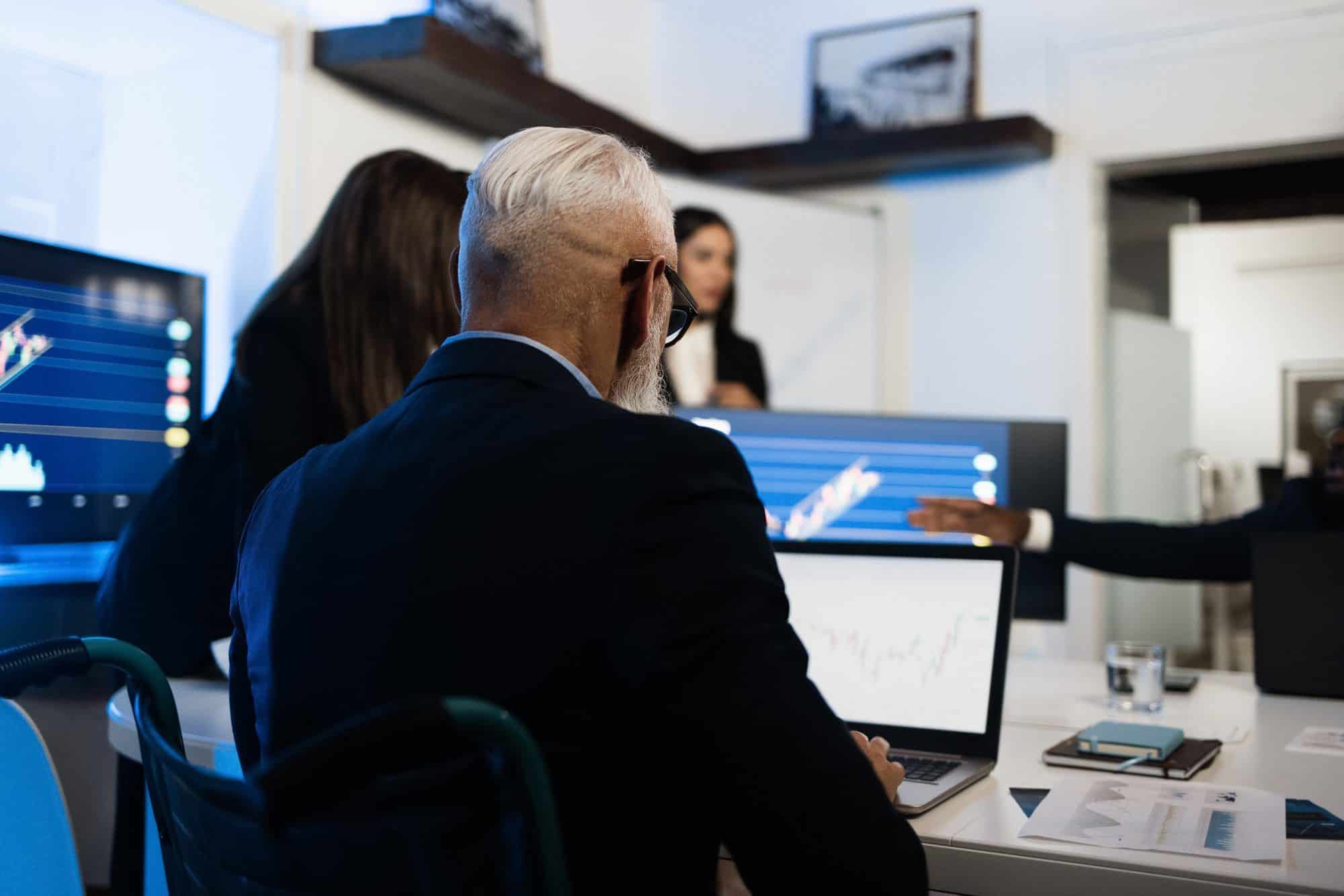 Trader team making stock market analysis conference inside hedge fund office